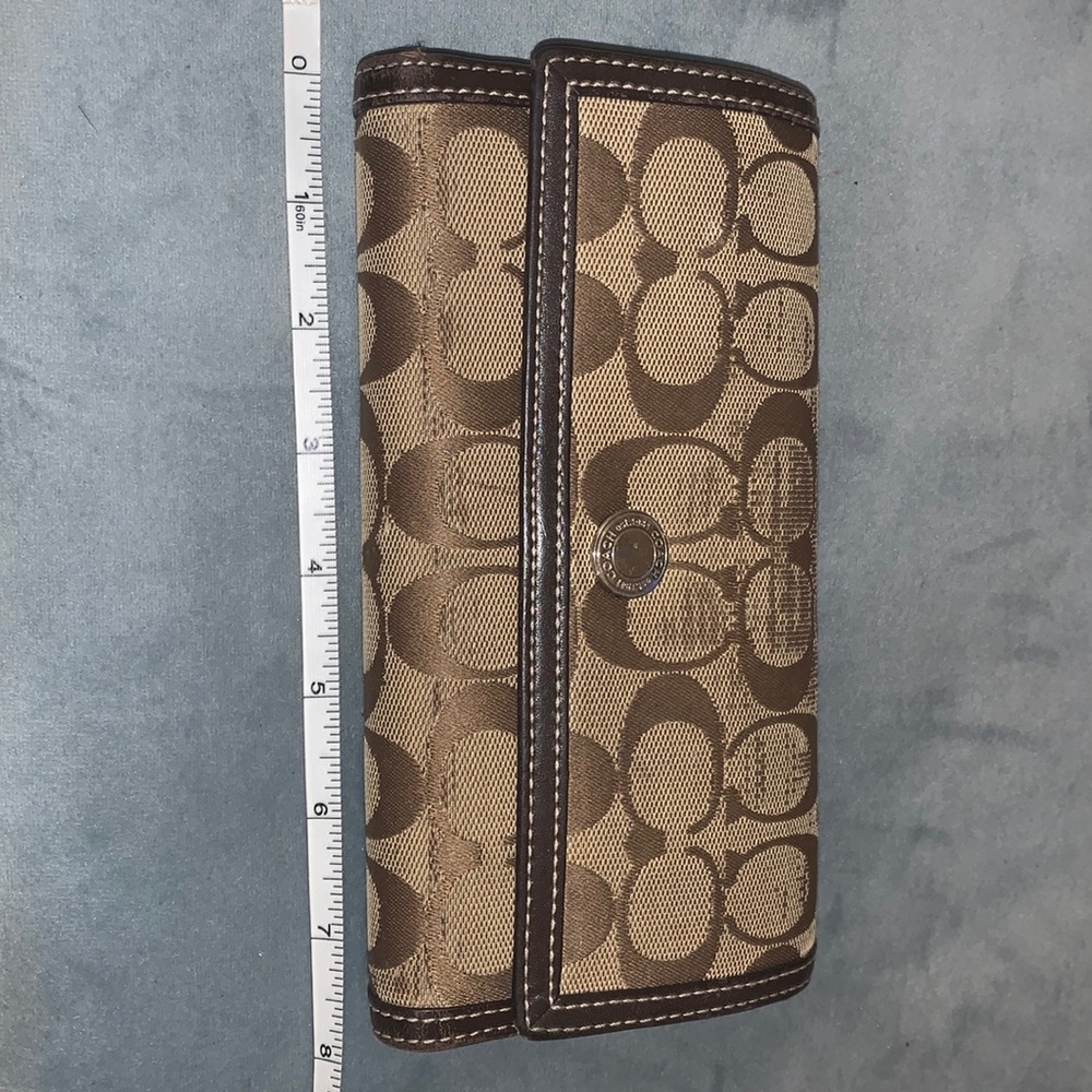 Used Coach brown and beige wallet.